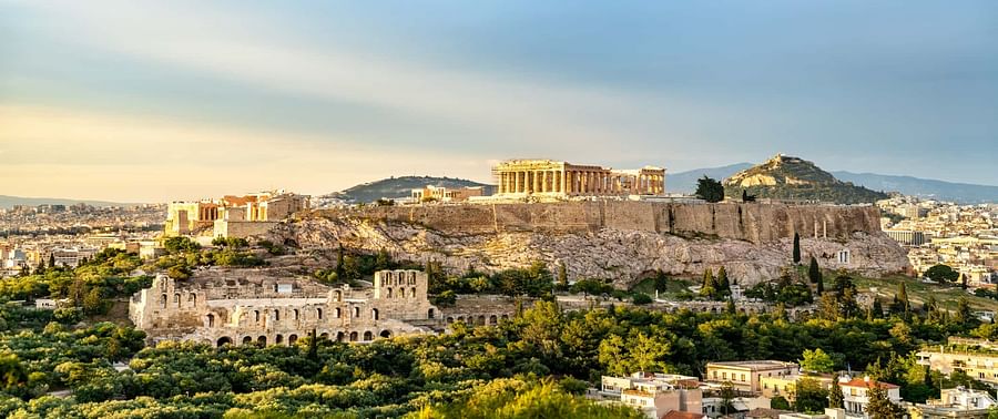 Panoramic daytime view of Athens cityscape showcasing its historic architecture